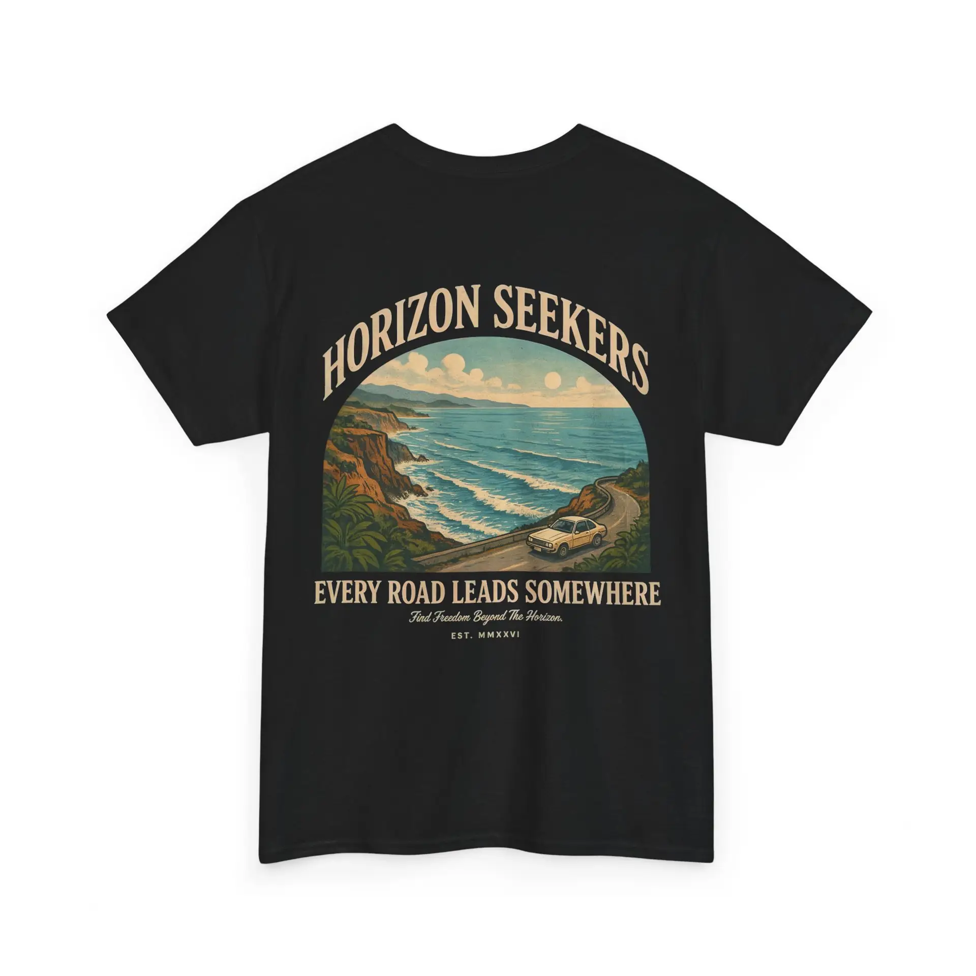 Someone wearing a blue Horizon Seekers graphic t-shirt featuring a vintage coastal road illustration with ocean cliffs, a retro car, bold typography reading "Every Road Leads Somewhere," and a nostalgic travel-inspired design in a professional studio.