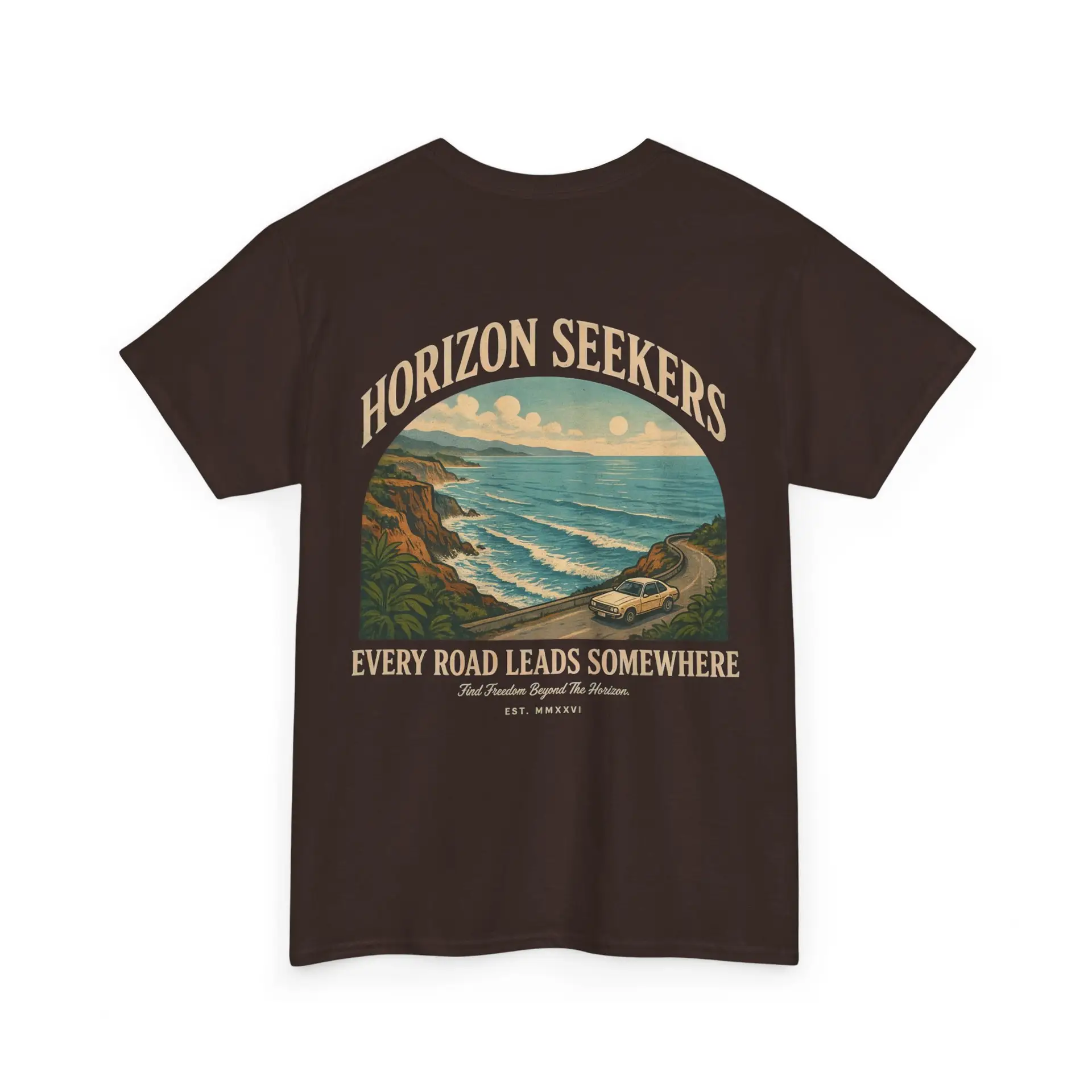 Someone wearing a blue Horizon Seekers graphic t-shirt featuring a vintage coastal road illustration with ocean cliffs, a retro car, bold typography reading "Every Road Leads Somewhere," and a nostalgic travel-inspired design in a professional studio.