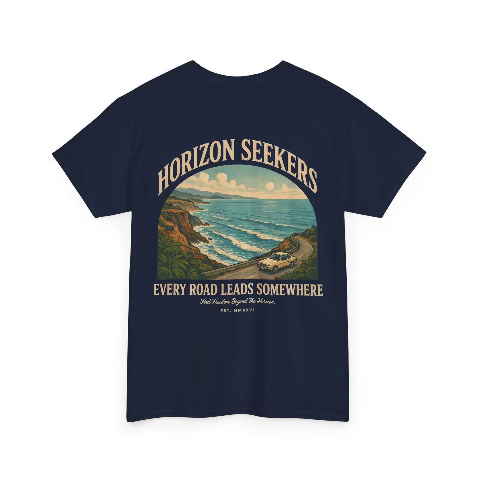 Someone wearing a blue Horizon Seekers graphic t-shirt featuring a vintage coastal road illustration with ocean cliffs, a retro car, bold typography reading "Every Road Leads Somewhere," and a nostalgic travel-inspired design in a professional studio.