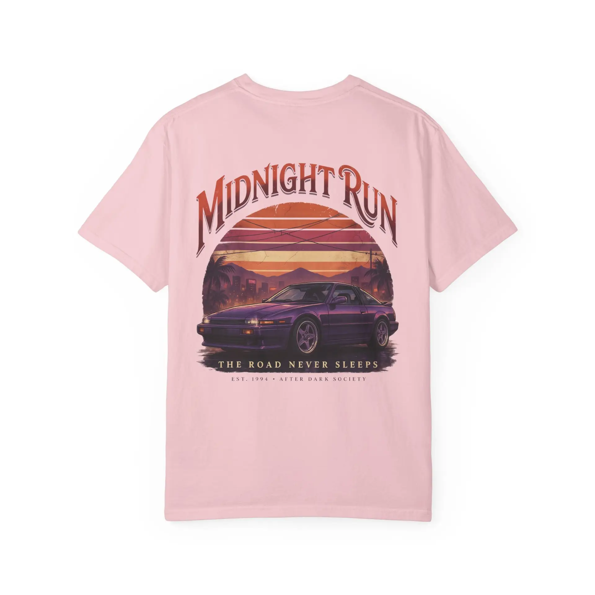Person wearing a Midnight Run graphic t-shirt featuring a retro-inspired neon cityscape, classic late-night driving artwork, vibrant 90s color palette, and bold vintage typography, photographed in a professional studio.