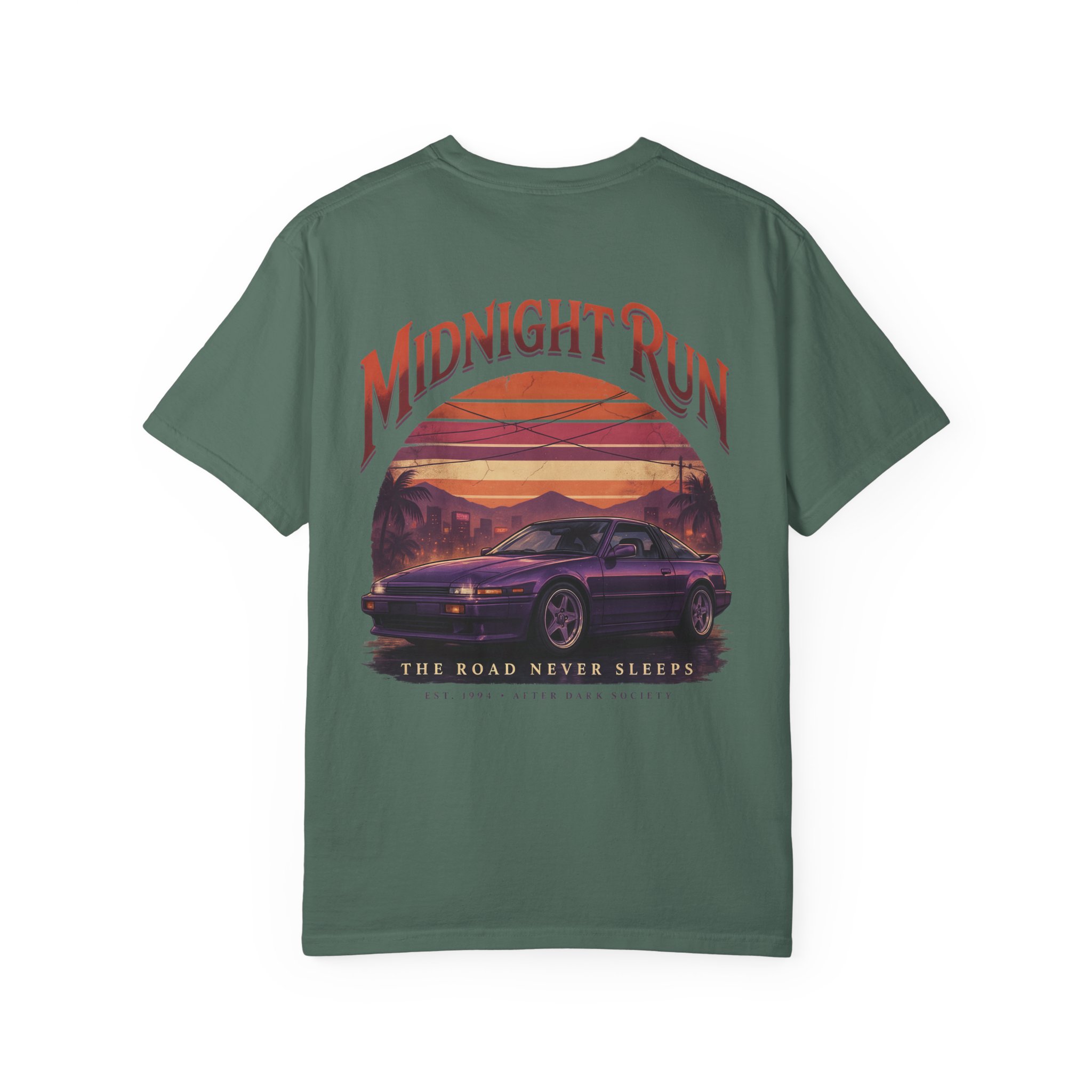 Person wearing a Midnight Run graphic t-shirt featuring a retro-inspired neon cityscape, classic late-night driving artwork, vibrant 90s color palette, and bold vintage typography, photographed in a professional studio.