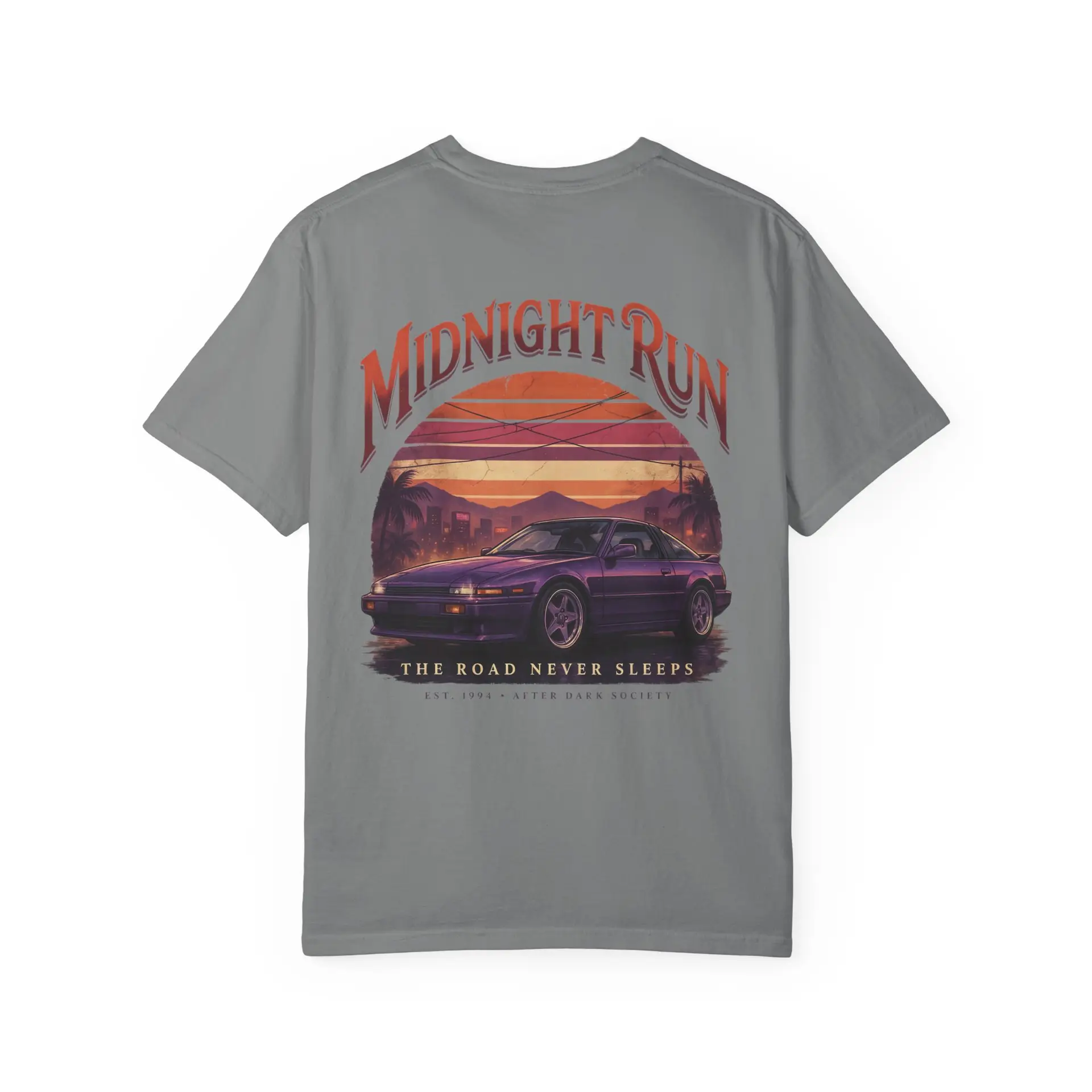 Person wearing a Midnight Run graphic t-shirt featuring a retro-inspired neon cityscape, classic late-night driving artwork, vibrant 90s color palette, and bold vintage typography, photographed in a professional studio.