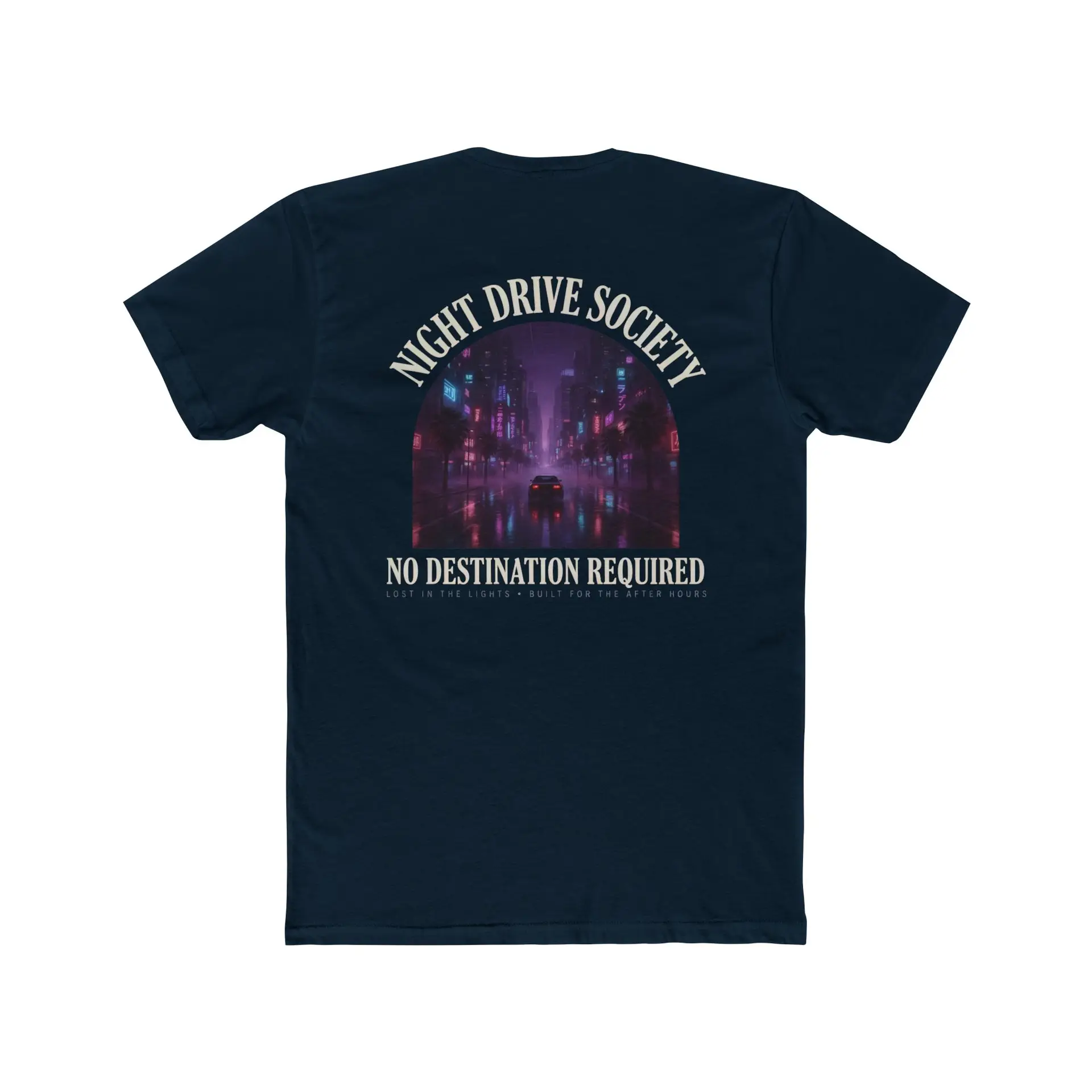 Person wearing a Night Drive Society graphic t-shirt featuring a retro-futuristic neon city skyline, rain-soaked streets, towering palm trees, and a classic car driving into the night with bold typography reading "No Destination Required" and "Lost In The Lights • Built For The After Hours," photographed in a professional studio.