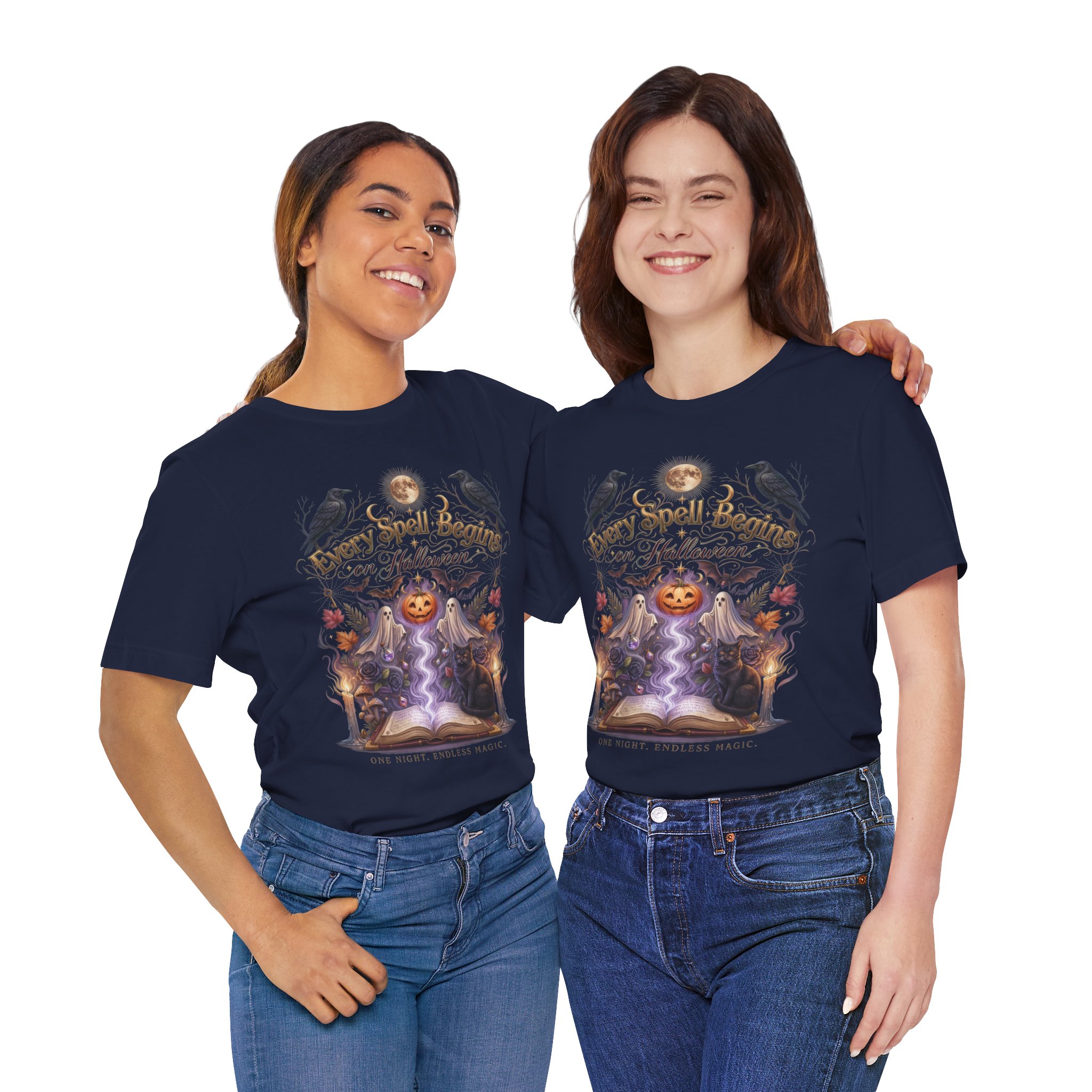 Woman wearing a black Bella+Canvas Halloween graphic t-shirt featuring a vintage illustration of an enchanted spell book, pumpkin, ghosts, candles, ravens, and the phrase "Every Spell Begins on Halloween."