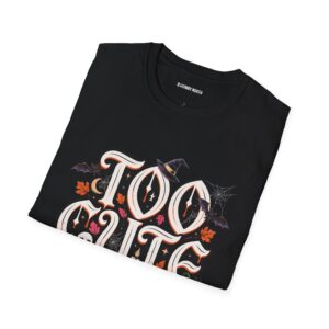 Woman wearing a black Too Cute To Haunt Halloween graphic t-shirt featuring vintage typography, a cute ghost, pumpkin, autumn leaves, and spooky accents in a professional studio.