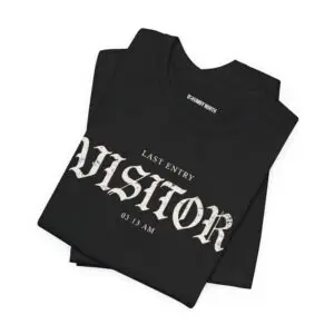 Image Alt Text (Front) Black Bella+Canvas 3001 unisex t-shirt featuring a vintage gothic "Visitor" front graphic with minimalist horror typography, modeled in a studio setting. Image Alt Text (Back) Back view of a black Bella+Canvas 3001 unisex t-shirt featuring "The Last Visitor" gothic horror back graphic with vintage typography and subtle distressed details, modeled in a studio setting.