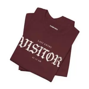 Image Alt Text (Front) Black Bella+Canvas 3001 unisex t-shirt featuring a vintage gothic "Visitor" front graphic with minimalist horror typography, modeled in a studio setting. Image Alt Text (Back) Back view of a black Bella+Canvas 3001 unisex t-shirt featuring "The Last Visitor" gothic horror back graphic with vintage typography and subtle distressed details, modeled in a studio setting.