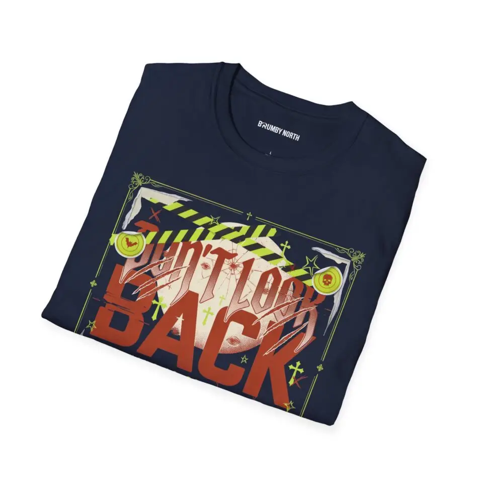 Woman wearing a navy blue Watch Your Back vintage Halloween graphic unisex t-shirt with distressed typography and spooky artwork on a white studio background.