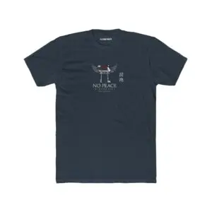 Person wearing a black No Peace In Paradise graphic t-shirt featuring a hooded figure with angel wings beneath a traditional Japanese torii gate, set against a crimson moon with ravens, floral elements, and gothic typography reading "Built From Chaos" and "Everything Beautiful Comes From Damage," photographed in a professional studio.