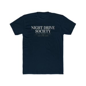 Person wearing a Night Drive Society graphic t-shirt featuring a retro-futuristic neon city skyline, rain-soaked streets, towering palm trees, and a classic car driving into the night with bold typography reading "No Destination Required" and "Lost In The Lights • Built For The After Hours," photographed in a professional studio.