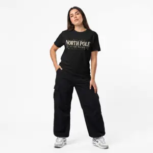 Unisex Gildan 64000 Christmas t-shirt featuring the "North Pole After Hours" vintage typography design with festive holly leaves and the "Winter Nights Since 1823" tagline on the front.