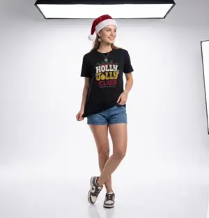 Holly Jolly Club retro Christmas graphic T-shirt on female model Black Holly Jolly Club holiday graphic tee front view Vintage Christmas typography unisex T-shirt Retro festive Christmas shirt with holly leaf design