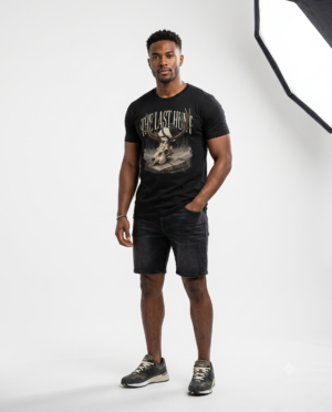 Woman wearing a black The Last Hunt premium cotton t-shirt featuring a rustic deer skull graphic with vintage outdoor-inspired artwork in a professional studio.