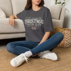 Minimalist Christmas Social Club graphic printed on a unisex Gildan 64000 t-shirt featuring vintage typography, festive holiday foliage, and the "Holiday Edition" tagline.