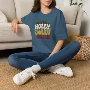 Holly Jolly Club retro Christmas graphic T-shirt on female model Black Holly Jolly Club holiday graphic tee front view Vintage Christmas typography unisex T-shirt Retro festive Christmas shirt with holly leaf design