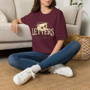 Letters from the North Pole vintage Christmas graphic T-shirt Burgundy Christmas mail graphic tee on female model North Pole Post holiday unisex T-shirt front view Vintage Christmas letter graphic premium cotton shirt
