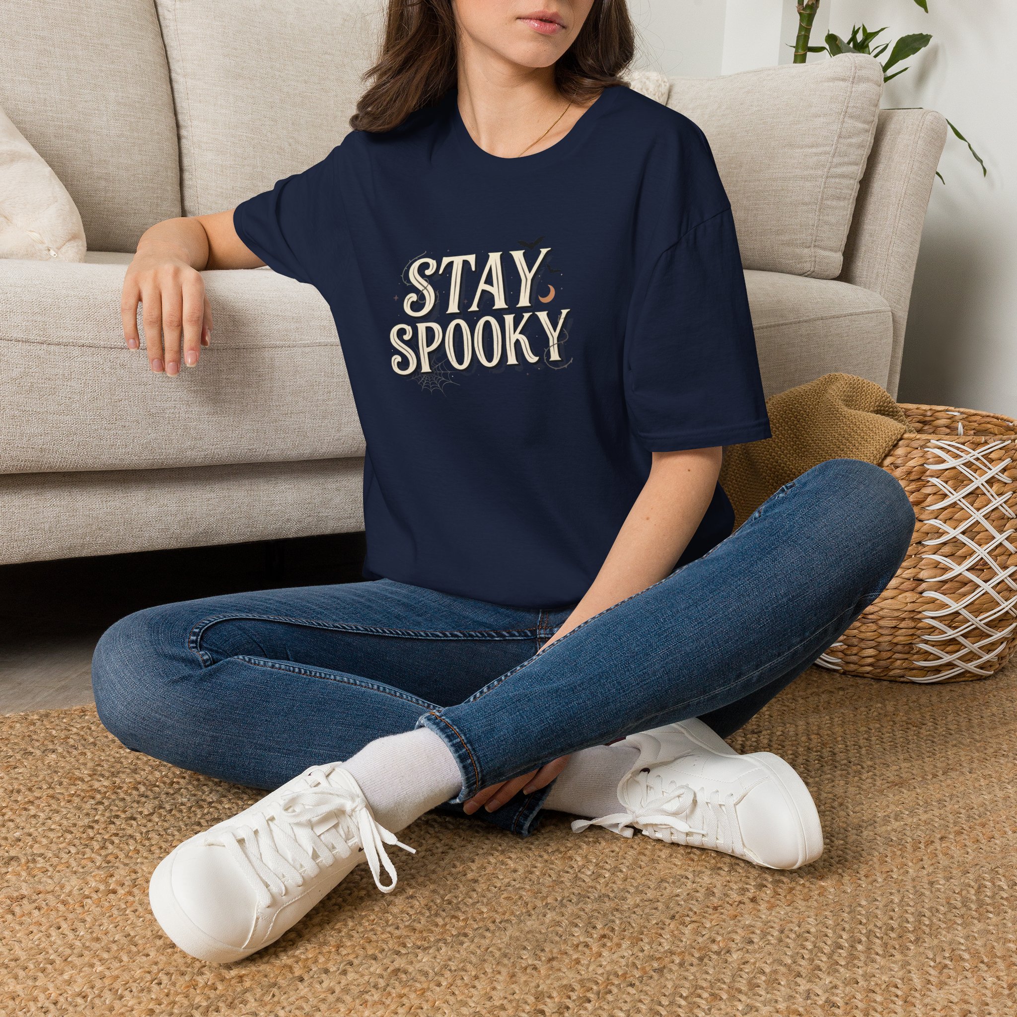 Model wearing a black Stay Spooky Halloween t-shirt featuring a retro script chest graphic with subtle Halloween accents.