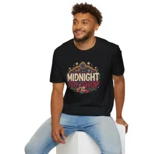 Woman wearing a black Midnight Toy Shop vintage Christmas graphic unisex t-shirt featuring retro holiday typography and festive toy store artwork while wearing a Santa hat in a white studio setting.