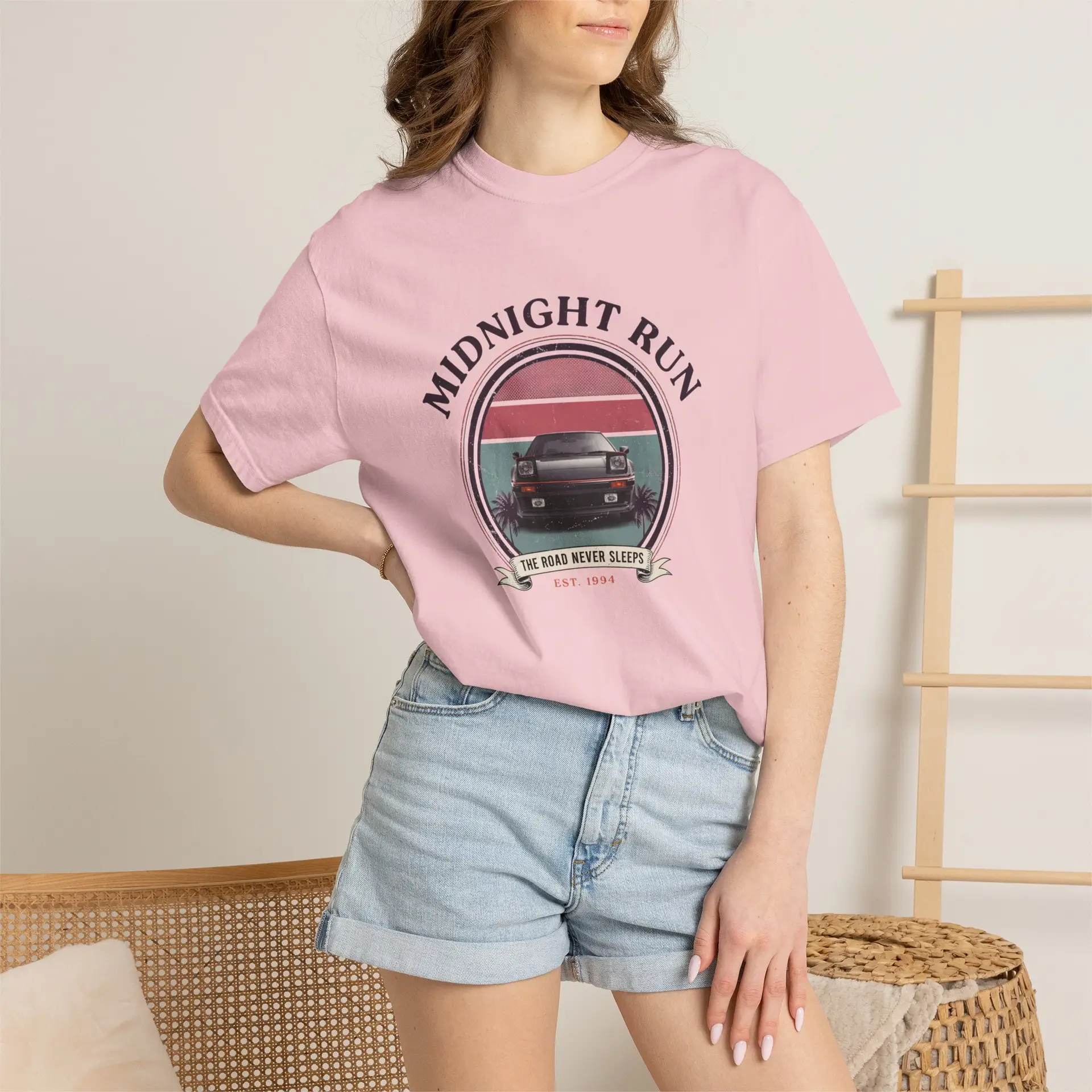 Person wearing a Midnight Run graphic t-shirt featuring a retro-inspired neon cityscape, classic late-night driving artwork, vibrant 90s color palette, and bold vintage typography, photographed in a professional studio.
