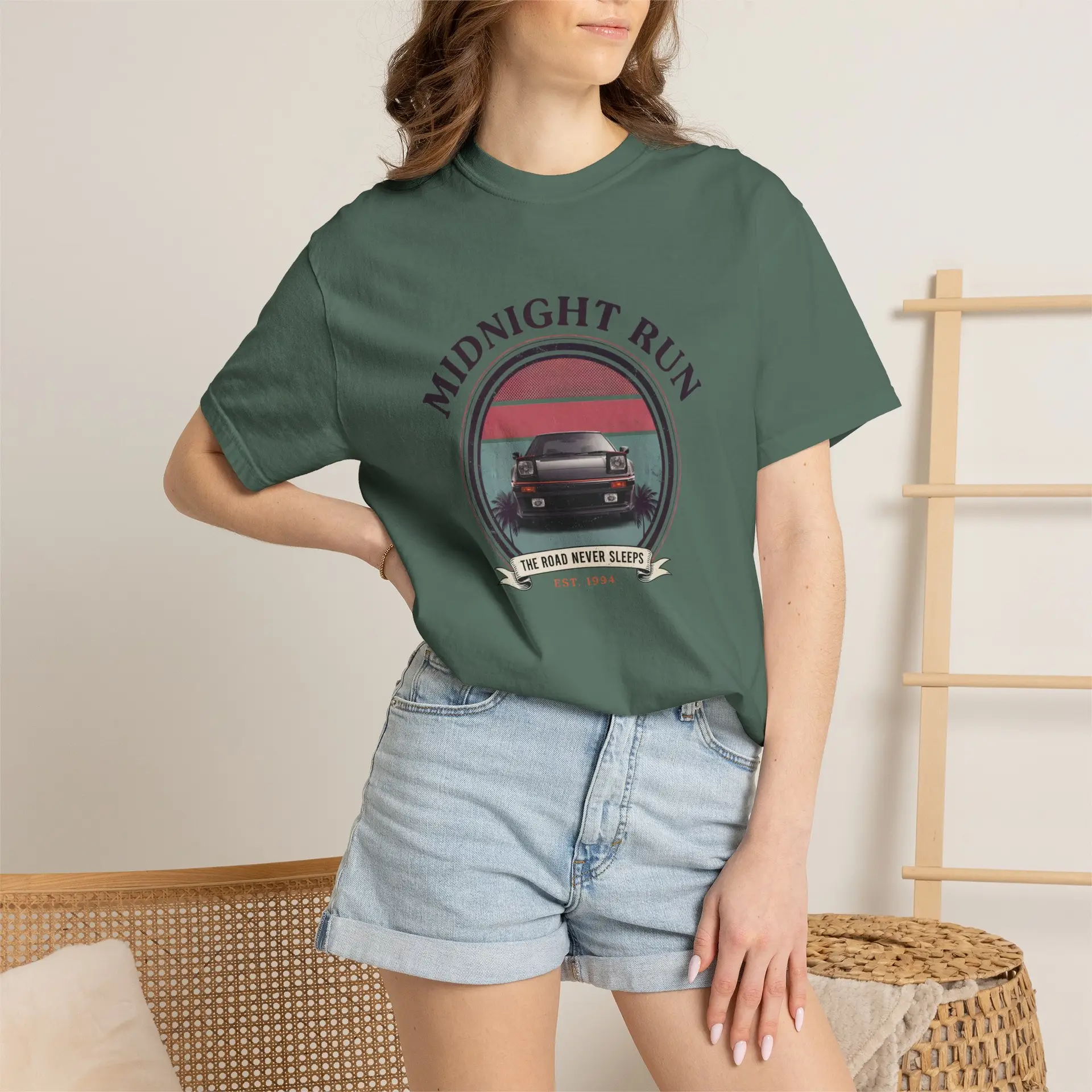 Person wearing a Midnight Run graphic t-shirt featuring a retro-inspired neon cityscape, classic late-night driving artwork, vibrant 90s color palette, and bold vintage typography, photographed in a professional studio.