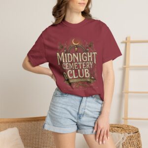 Front View Woman wearing a Comfort Colors Midnight Cemetery Club Halloween graphic t-shirt featuring vintage gothic typography, moonlit cemetery artwork, and a relaxed garment-dyed fit. Lifestyle Alt Text Premium Comfort Colors 1717 garment-dyed Halloween t-shirt with Midnight Cemetery Club vintage cemetery design, photographed on a female model in a casual lifestyle setting.