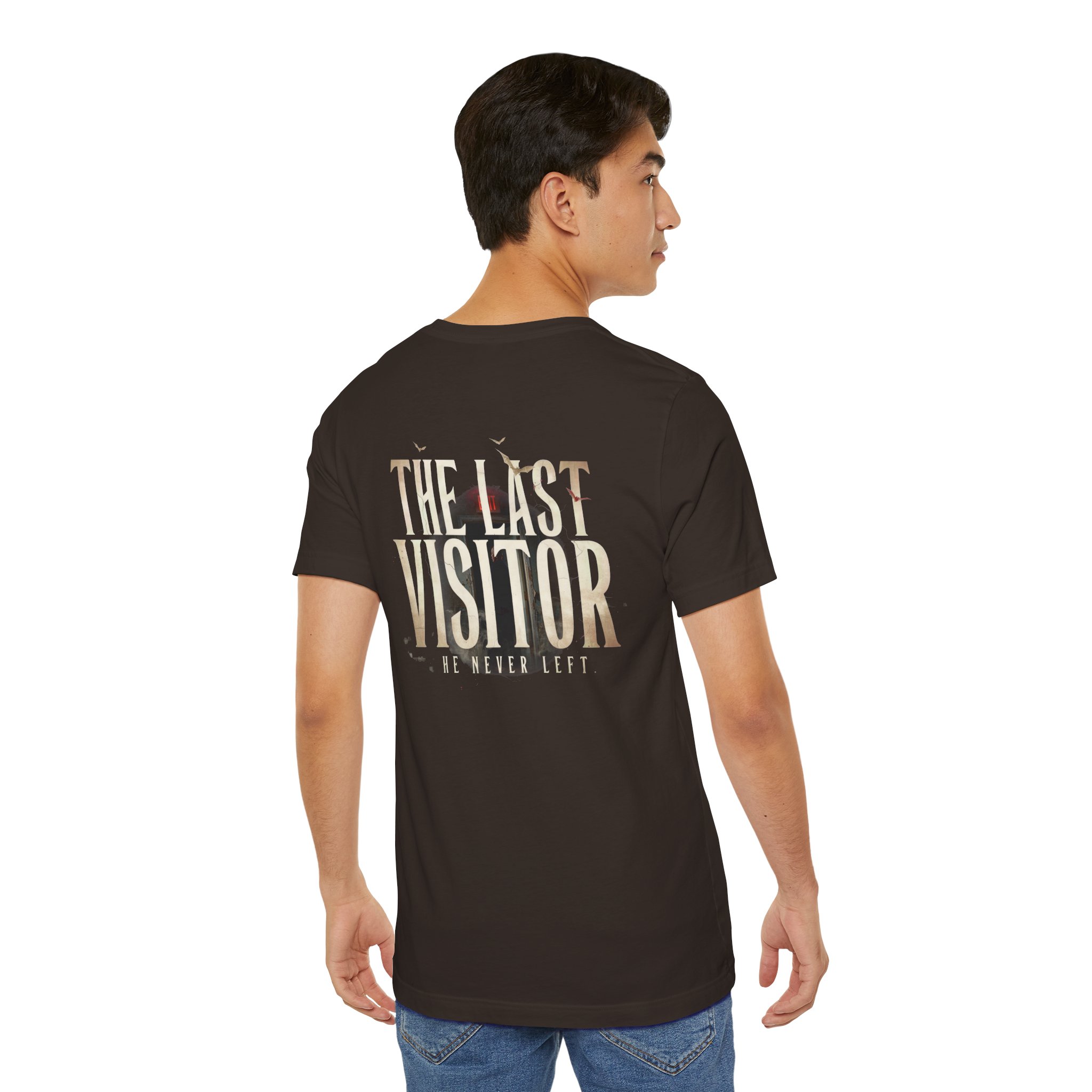 Image Alt Text (Front) Black Bella+Canvas 3001 unisex t-shirt featuring a vintage gothic "Visitor" front graphic with minimalist horror typography, modeled in a studio setting. Image Alt Text (Back) Back view of a black Bella+Canvas 3001 unisex t-shirt featuring "The Last Visitor" gothic horror back graphic with vintage typography and subtle distressed details, modeled in a studio setting.