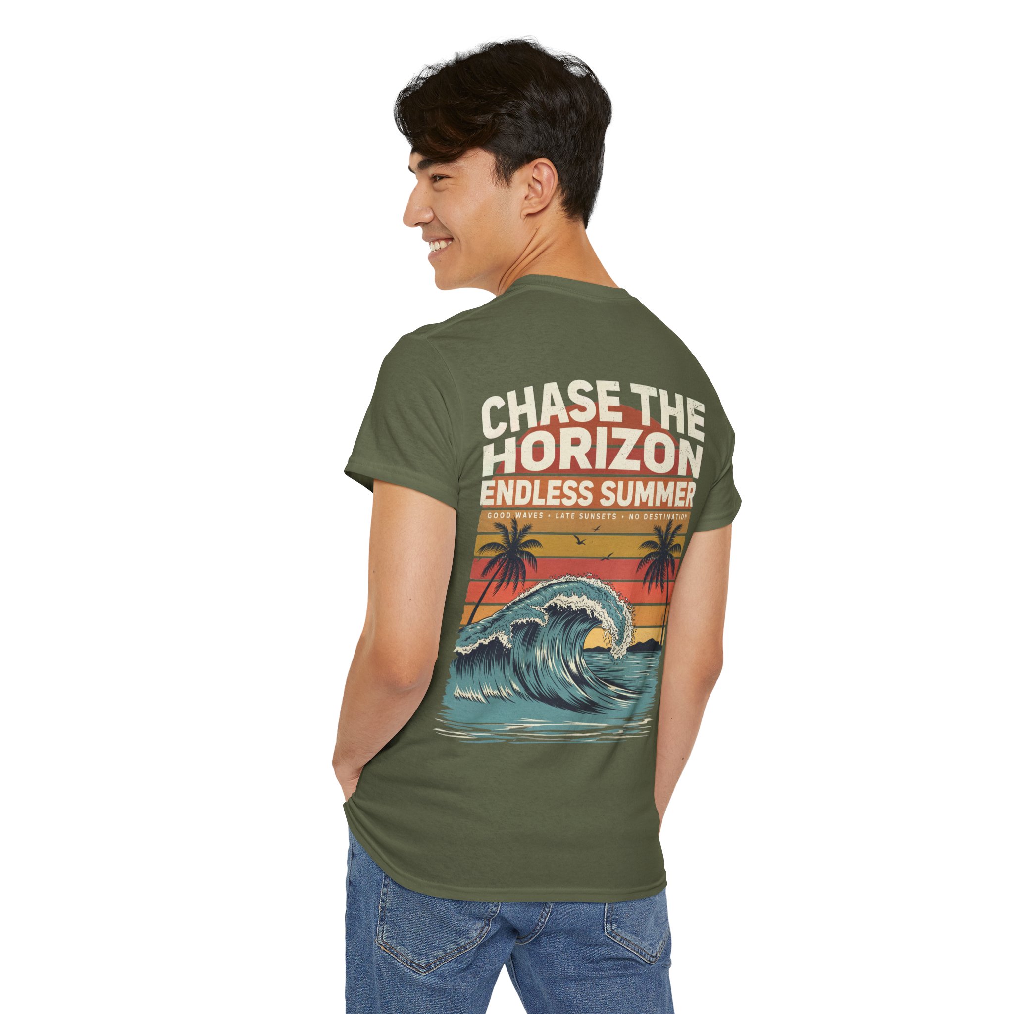 Woman wearing an olive green Chase The Horizon vintage surf graphic unisex heavy cotton t-shirt featuring a retro sunset chest print in a professional studio. Back Image Back view of woman wearing an olive green Chase The Horizon vintage surf graphic t-shirt with a large retro ocean wave and sunset illustration in a studio setting