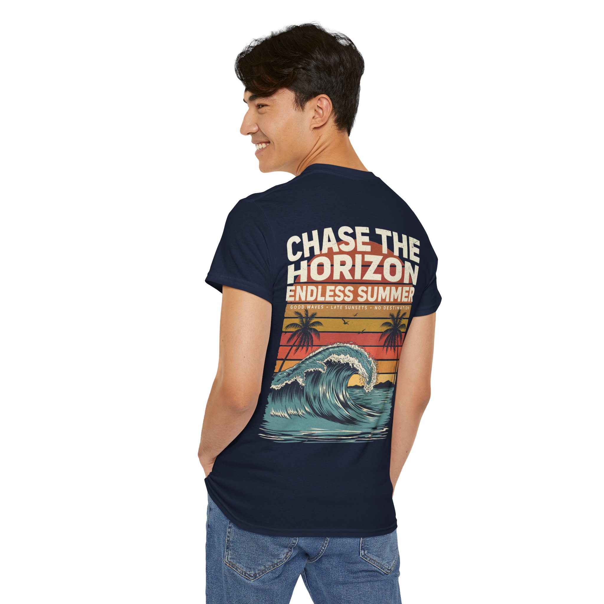 Woman wearing an olive green Chase The Horizon vintage surf graphic unisex heavy cotton t-shirt featuring a retro sunset chest print in a professional studio. Back Image Back view of woman wearing an olive green Chase The Horizon vintage surf graphic t-shirt with a large retro ocean wave and sunset illustration in a studio setting