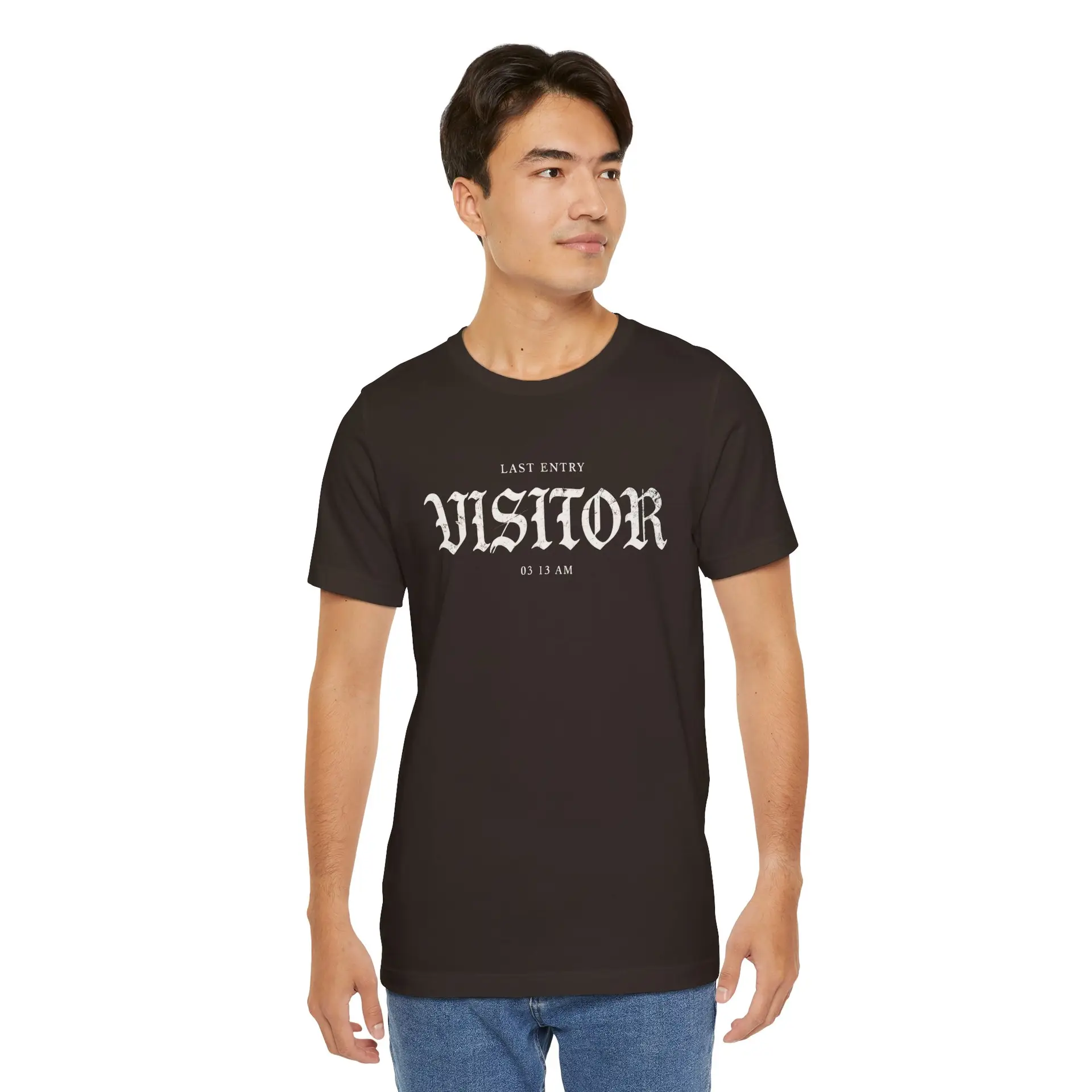 Image Alt Text (Front) Black Bella+Canvas 3001 unisex t-shirt featuring a vintage gothic "Visitor" front graphic with minimalist horror typography, modeled in a studio setting. Image Alt Text (Back) Back view of a black Bella+Canvas 3001 unisex t-shirt featuring "The Last Visitor" gothic horror back graphic with vintage typography and subtle distressed details, modeled in a studio setting.