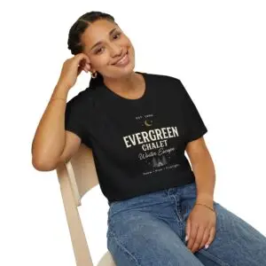 Evergreen Chalet Winter Escape Christmas graphic T-shirt on female model Forest green vintage Christmas cabin graphic tee front view Cozy winter lodge inspired unisex holiday T-shirt Evergreen Chalet Christmas shirt premium cotton graphic tee