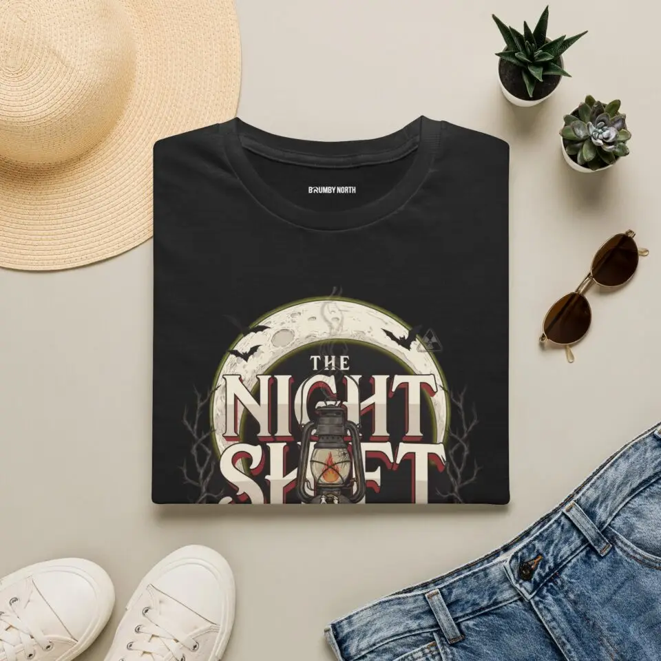 Model wearing The Night Shift vintage lantern moon graphic unisex T-shirt Short Product Text Made for the hours after dark. The Night Shift T-Shirt pairs a vintage lantern moon graphic with a slightly distressed finish for an understated nighttime streetwear look. SEO Keywords / Tags the night shift t-shirt, night shift graphic tee, vintage lantern t-shirt, moon graphic tee, after dark t-shirt, night owl shirt, vintage streetwear, distressed graphic tee, nighttime t-shirt, unisex graphic tee, retro graphic t-shirt