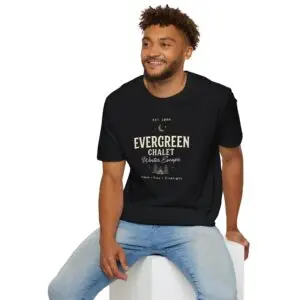 Evergreen Chalet Winter Escape Christmas graphic T-shirt on female model Forest green vintage Christmas cabin graphic tee front view Cozy winter lodge inspired unisex holiday T-shirt Evergreen Chalet Christmas shirt premium cotton graphic tee