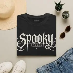 Model wearing a black Spooky Season gothic Halloween graphic unisex T-shirt Short Product Text Lean into Halloween season with a vintage gothic “spooky season” graphic tee. A lightweight unisex T-shirt made for autumn streetwear, horror nights and everyday casual looks.