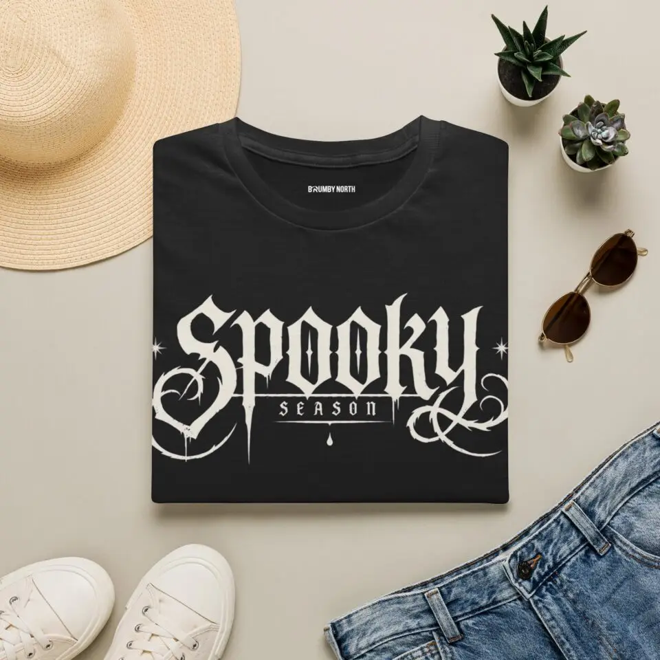 Model wearing a black Spooky Season gothic Halloween graphic unisex T-shirt Short Product Text Lean into Halloween season with a vintage gothic “spooky season” graphic tee. A lightweight unisex T-shirt made for autumn streetwear, horror nights and everyday casual looks.