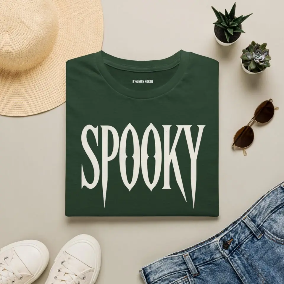 Model wearing a black unisex SPOOKY Halloween graphic T-shirt Short Product Text A bold “SPOOKY” graphic tee with a vintage gothic horror feel. Lightweight, unisex and easy to style for Halloween season or everyday streetwear.