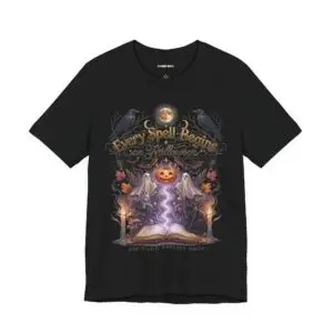 Woman wearing a black Bella+Canvas Halloween graphic t-shirt featuring a vintage illustration of an enchanted spell book, pumpkin, ghosts, candles, ravens, and the phrase "Every Spell Begins on Halloween."