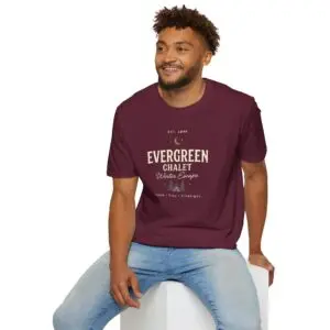 Evergreen Chalet Winter Escape Christmas graphic T-shirt on female model Forest green vintage Christmas cabin graphic tee front view Cozy winter lodge inspired unisex holiday T-shirt Evergreen Chalet Christmas shirt premium cotton graphic tee