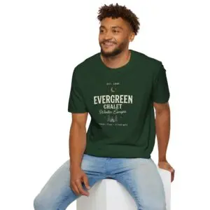 Evergreen Chalet Winter Escape Christmas graphic T-shirt on female model Forest green vintage Christmas cabin graphic tee front view Cozy winter lodge inspired unisex holiday T-shirt Evergreen Chalet Christmas shirt premium cotton graphic tee