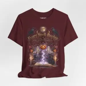 Woman wearing a black Bella+Canvas Halloween graphic t-shirt featuring a vintage illustration of an enchanted spell book, pumpkin, ghosts, candles, ravens, and the phrase "Every Spell Begins on Halloween."