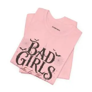 Front Mockup 1 Woman wearing the Bad Girls Go to the Haunted House Halloween graphic t-shirt featuring vintage typography, pumpkins, bats, and spiderweb artwork. Front Mockup 2 Cute Halloween graphic tee with "Bad Girls Go to the Haunted House" design on a premium Bella+Canvas 3001 t-shirt. Front Mockup 3 Women's spooky season t-shirt featuring vintage pumpkin artwork and playful Halloween typography. Front Mockup 4 Bella+Canvas Halloween t-shirt with gothic lettering, smiling jack-o'-lanterns, bats, and autumn floral details. Back Mockup 1 Back view of the Bella+Canvas 3001 Halloween graphic t-shirt showing the modern retail fit. Back Mockup 2 Rear view of the premium unisex Halloween t-shirt from Brumbynorth. Close-up 1 Close-up of the premium Halloween graphic print showing detailed typography, pumpkins, and bats. Close-up 2 Detailed close-up of the DTF printed Halloween artwork on soft Airlume combed ring-spun cotton