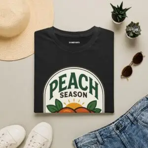Peach Season vintage graphic T-shirt worn by a female model with relaxed black jeans in a studio setting. Shorter SEO Alt Text Peach Season vintage fruit graphic unisex T-shirt