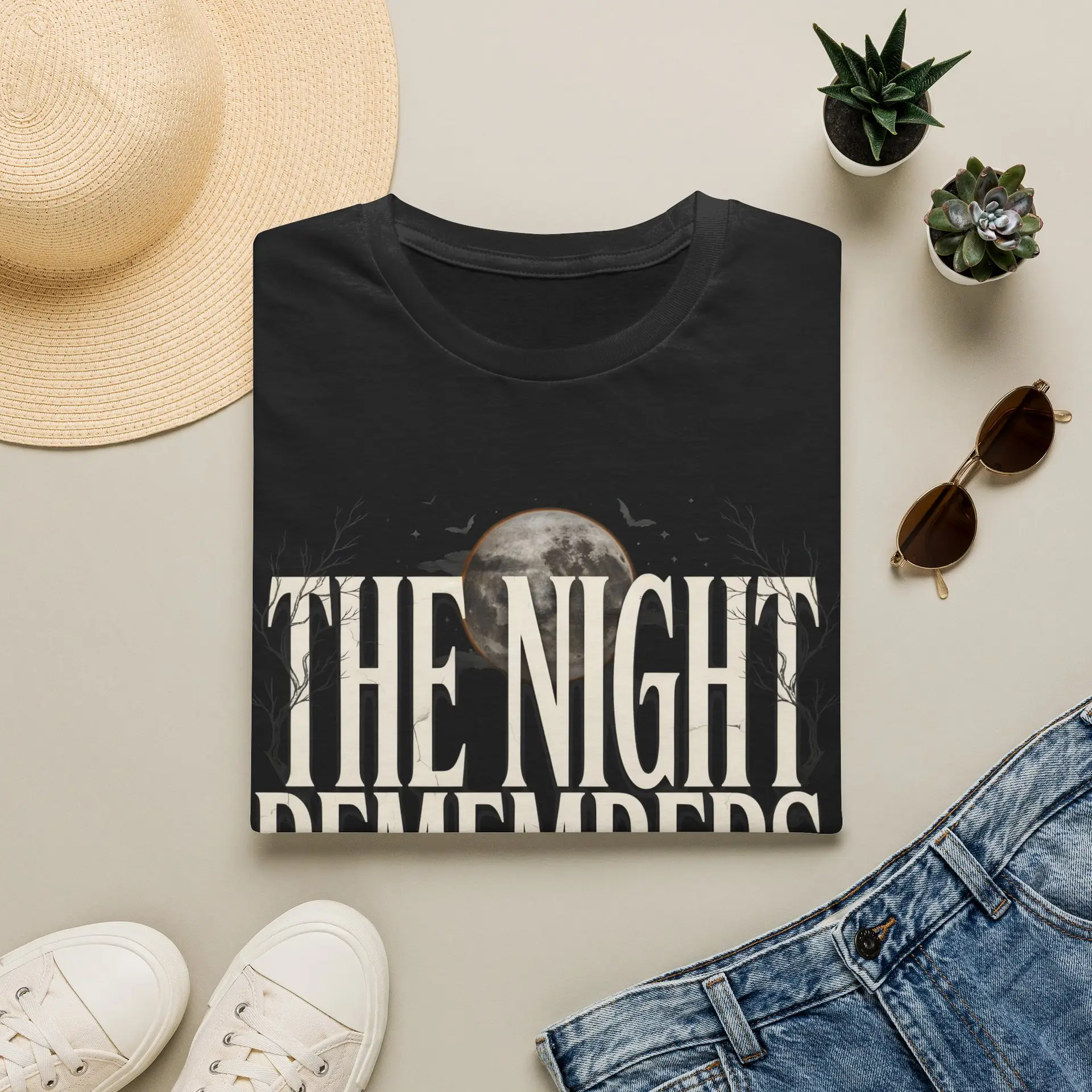 Front Mockup 1 The Night Remembers gothic moon graphic t-shirt featuring vintage typography, full moon, bats and haunted tree artwork. Front Mockup 2 Women's gothic Halloween graphic tee with The Night Remembers vintage moon design. Front Mockup 3 Vintage Halloween t-shirt with bold gothic typography and spooky moon artwork. Front Mockup 4 Dark aesthetic graphic t-shirt featuring The Night Remembers moon and haunted forest illustration. Back Mockup 1 Back view of The Night Remembers gothic Halloween t-shirt showing premium unisex fit. Back Mockup 2 Rear view of premium Gildan 64000 Halloween graphic tee from Brumbynorth. Close-up 1 Close-up of premium DTG printed gothic moon artwork on soft ring-spun cotton fabric. Close-up 2 Detailed close-up of The Night Remembers Halloween graphic showing crisp vintage typography and moon illustration.