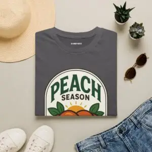 Peach Season vintage graphic T-shirt worn by a female model with relaxed black jeans in a studio setting. Shorter SEO Alt Text Peach Season vintage fruit graphic unisex T-shirt