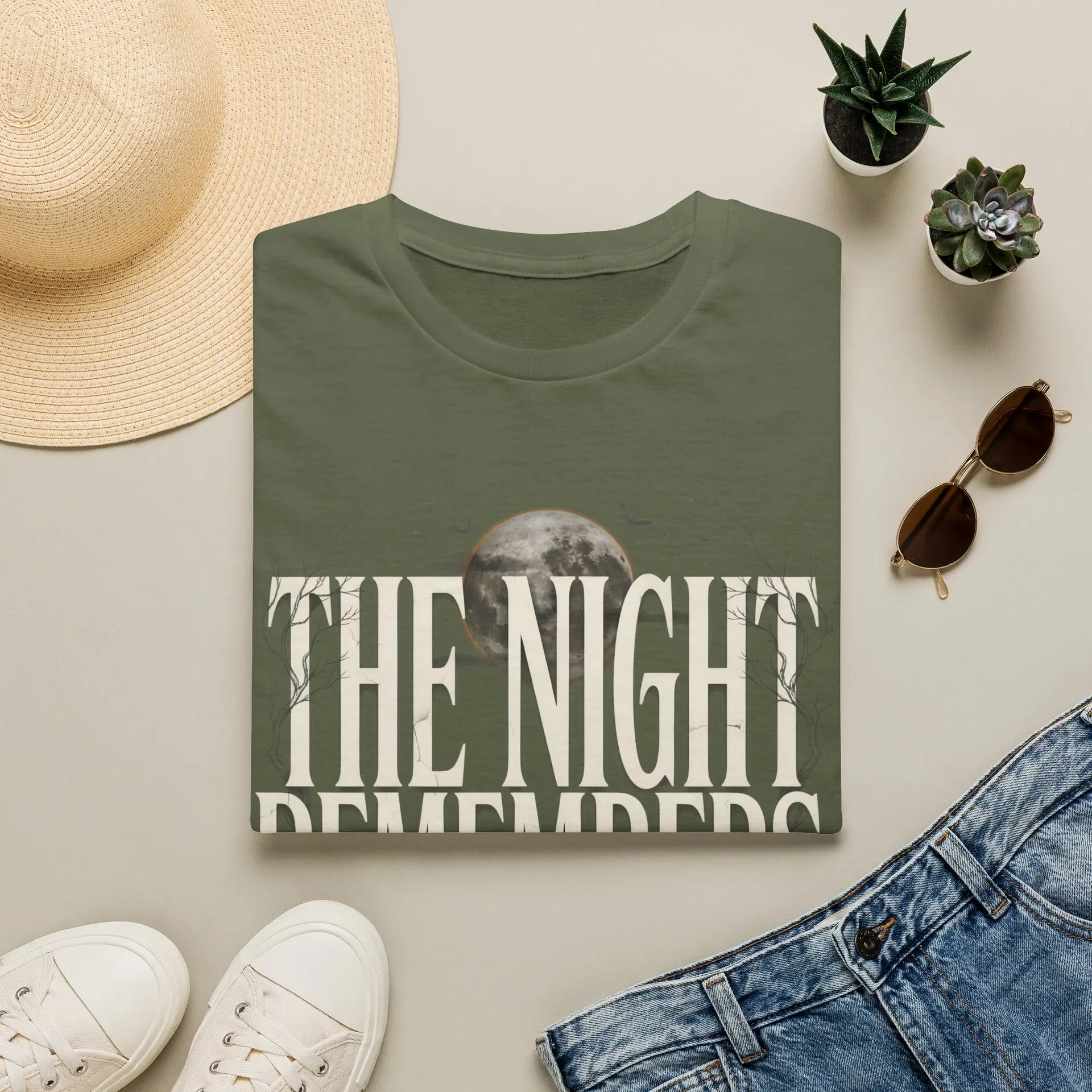 Front Mockup 1 The Night Remembers gothic moon graphic t-shirt featuring vintage typography, full moon, bats and haunted tree artwork. Front Mockup 2 Women's gothic Halloween graphic tee with The Night Remembers vintage moon design. Front Mockup 3 Vintage Halloween t-shirt with bold gothic typography and spooky moon artwork. Front Mockup 4 Dark aesthetic graphic t-shirt featuring The Night Remembers moon and haunted forest illustration. Back Mockup 1 Back view of The Night Remembers gothic Halloween t-shirt showing premium unisex fit. Back Mockup 2 Rear view of premium Gildan 64000 Halloween graphic tee from Brumbynorth. Close-up 1 Close-up of premium DTG printed gothic moon artwork on soft ring-spun cotton fabric. Close-up 2 Detailed close-up of The Night Remembers Halloween graphic showing crisp vintage typography and moon illustration.