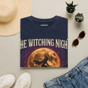 Front view of a black Gildan Softstyle 64000 unisex t-shirt featuring "The Witching Night" vintage Halloween graphic with a full moon, flying witch, and gothic typography, modeled in a studio setting.