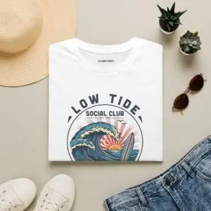 A laid-back surf tee built around a vintage coastal crest, curling wave, pastel sunset, and retro Low Tide Social Club lettering. Easy everyday streetwear with a relaxed summer feel.