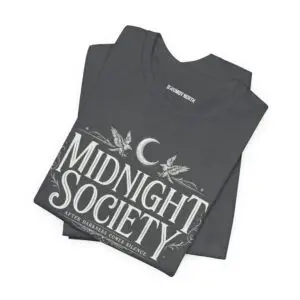 Midnight Society Gothic Halloween graphic t-shirt featuring vintage moon and bat front design. Bella+Canvas Midnight Society Halloween t-shirt with gothic front print on premium unisex cotton tee. Front view of Midnight Society spooky season graphic tee with moon, bats and vintage gothic typography. Premium Halloween graphic t-shirt with minimalist Midnight Society front artwork for autumn fashion. Back Images (2) Back view of Midnight Society Halloween t-shirt featuring large moonlit cemetery, gothic church and vintage horror artwork. Oversized gothic Halloween back graphic with cathedral, moon, ravens and vintage cemetery illustration on Bella+Canvas tee. Close-Up Images (2) Close-up of premium DTF printed Midnight Society graphic showing detailed gothic artwork and sharp vintage typography. Detailed close-up of moonlit cemetery Halloween print with distressed gothic illustration on soft Bella+Canvas cotton t-shirt