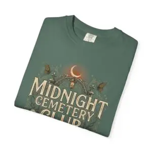 Front View Woman wearing a Comfort Colors Midnight Cemetery Club Halloween graphic t-shirt featuring vintage gothic typography, moonlit cemetery artwork, and a relaxed garment-dyed fit. Lifestyle Alt Text Premium Comfort Colors 1717 garment-dyed Halloween t-shirt with Midnight Cemetery Club vintage cemetery design, photographed on a female model in a casual lifestyle setting.