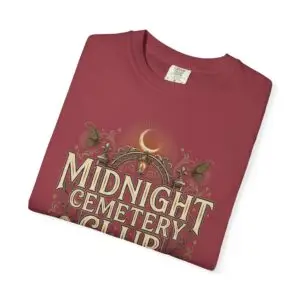 Front View Woman wearing a Comfort Colors Midnight Cemetery Club Halloween graphic t-shirt featuring vintage gothic typography, moonlit cemetery artwork, and a relaxed garment-dyed fit. Lifestyle Alt Text Premium Comfort Colors 1717 garment-dyed Halloween t-shirt with Midnight Cemetery Club vintage cemetery design, photographed on a female model in a casual lifestyle setting.