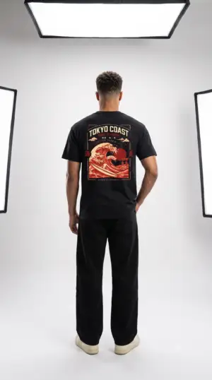 Tokyo Coast Surf Division Japanese wave graphic T-shirt shown from the back on a male model in a studio. Short SEO Alt Text Tokyo Coast Japanese wave graphic back print T-shirt
